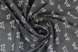 Swirled swatch Whiskers fabric (black fabric with repeated white cat top of head and whiskers outline allover)