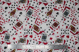 Flat swatch man cave themed fabric in cards red (deck of cards face up tossed collage on red background)
