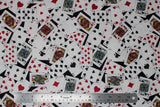 Flat swatch man cave themed fabric in cards black (deck of cards face up tossed collage on black background)