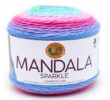 A cake of Lion Brand Mandala Sparkle yarn on white background in colourway draco (light blue, light aqua, lavender, hot pink, blue with metallic sparkles throughout)
