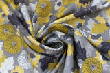Swirled swatch Flint fabric (grey fabric with busy collaged greyscale and yellow toned leaves, tree sprigs, pinecones, acorns and floral heads)
