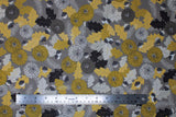 Flat swatch Flint fabric (grey fabric with busy collaged greyscale and yellow toned leaves, tree sprigs, pinecones, acorns and floral heads)