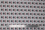 Flat swatch Bob Ross collection fabric in Bob Ross print (light grey fabric with tiled black and white Bob Ross heads with red signatures beneath)