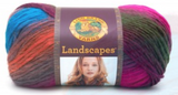 A ball of Lion Brand Landscapes yarn on white background in colourway tropics (orange, purple, fuchsia, olive, grey, blue)