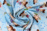 Swirled swatch magical themed printed fabric in print fairies (light blue marbled fabric with tiny blue stars and cartoon brunette fairies with two side buns and gold star wands, pink/blue/green/purple dresses)