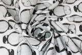Swirled swatch Moon fabric (white fabric with alternating direction lines of sleepy barn owls in white and black)