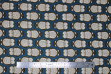 Flat swatch Lake fabric (deep blue fabric with alternating direction lines of sleepy barn owls in beige and brown)