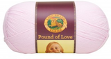 A ball of Lion Brand Pound of Love yarn on white background in shade pastel pink