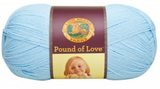 A ball of Lion Brand Pound of Love yarn on white background in shade pastel blue