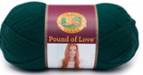 A ball of Lion Brand Pound of Love yarn on white background in shade hunter green