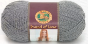 A ball of Lion Brand Pound of Love yarn on white background in an off white shade