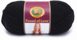 A ball of Lion Brand Pound of Love yarn on white background in shade black