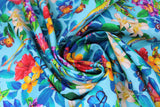 Swirled swatch Floral fabric (light blue fabric with busy tossed floral and greenery with tossed frogs and butterflies in full colour)