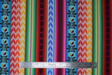 Flat swatch Multi fabric (vertical striped fabric in southwest style with geometric chevron style shapes and tribal look turtles: blue, red, orange, yellow, green, pink stripes)