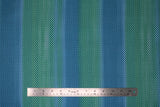 Flat swatch blue fabric (teal and light blue faded vertical stripes with mermaid scale pattern allover)