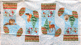 Full panel swatch - Stockings Panel (24" x 45") (white background with tossed blue snowflakes, 4 stocking side cut outs with green, white and red chevron detail along top thick border and around toe and heel, blue sky nature themed christmas graphics: deer, fox, racoon, squirrel, birds in branches, etc. with trees: makes 2 stockings)