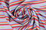 Swirled swatch morning stripes fabric (red, green, blue striped pattern with yellow floral within blue stripes, decorative slashes in green/red stripes)