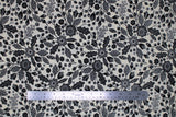 Flat swatch blooming linen fabric (off white fabric with busy black floral design allover decorative black floral and leaves with fruit and patterns/designs in white within the black)