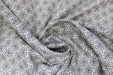 Swirled swatch blossoming linen fabric (off white fabric with small black floral head outlines with tiny leaves around allover)