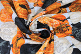 Swirled swatch Tossed Pumpkins fabric (light grey fabric with tossed black, orange and white pumpkins with ornate style decorative patterns on pumpkins and tossed birds, trees and spiders)