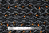Flat swatch Decorative Webs fabric (black fabric with ornate/victorian style decor and skulls in background with thick bubbled stripes outlined in swirly leaves with grey spider webs and orange spiders)