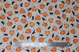 Flat swatch Crows fabric (pale beige fabric with subtle white spiderweb print background, tossed orange pumpkins with ornate white decoration, tossed black crows and tossed black stars)