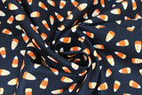 Swirled swatch Candy Corn Black fabric (black fabric with tossed candy corn with ornate/decorative pattern in orange sections)