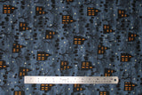 Flat swatch Haunted House fabric (grey misty sky looking fabric with crooked lines of halloween silhouette emblems: haunted houses with glowing orange windows, grave stones, trees, pumpkins, birds, and tossed white stars)