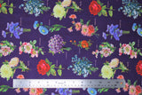 Flat swatch purple bouquets (dark purple fabric with full colour small bouquets of floral allover with small light purple cursive labels)