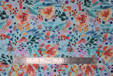 Flat swatch blue fabric (light blue fabric with large tossed floral heads, stems and dots in watercolour look in blue, red, purple, orange, yellow colourway)