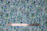 Flat swatch leaf fabric (white fabric with blue and teal leafy greenery style plants and dots allover)