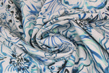 Swirled swatch Jade fabric (white fabric with large teal and blue floral head outlines and greenery drawings allover)