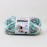 A ball of Bernat Pipsqueak yarn in shade Seaspray Varg (white, mint and grey shades)