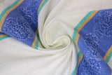 Swirled swatch Blue Fall t-toweling fabric (white fabric with blue, teal and mustard top and bottom border stripes with clustered pinecones design)