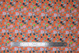 Flat swatch deadlines fabric (orange fabric with tossed clocks: wall clocks, alarm clocks, circular and rectangle clocks in various styles and colours allover)