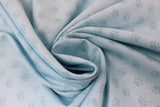 Swirled swatch Paw Prints fabric (pale blue fabric with pale teal paw prints allover)