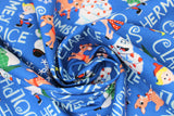 Swirled swatch navy fabric (blue fabric with white character name texts allover horizontal and vertical "Rudolph" "Clarice" etc. with tossed full colour movie characters and snowflakes)