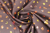 Swirled swatch Dark Brown fabric (dark brown fabric with small loosely tossed fall emblems in illustrative style: leaves, mushrooms, foxes, bear heads)