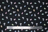 Flat swatch Black fabric (black fabric with small tossed white and grey ghosts allover with different coloured outlines, faint grey stars)