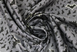 Swirled swatch Grey Bats fabric (medium grey fabric with tossed black bats allover in various sizes and medium tossed black bats with white outlines)