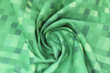 Swirled swatch Minecraft (licensed) printed fabric in Minecraft pixels (multi green shade pixel collage)