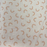 Square swatch double gauze fabric with small faint rainbows on white