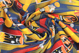 Swirled swatch licensed Star Wars badges fabric in Rebellion Badge ("REBEL" badges, red and yellow speed lines, aircraft on dark blue)