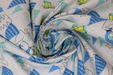 Swirled swatch child snow day fabric (white fabric with lines of assorted blue trees and black tree outlines, green the child tossed making snow angels and making a snowman, zooming around in a space pod, tossed allover)