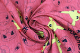 Swirled swatch Pikachu fabric (pale red fabric with tossed coloured Pikachu heads, and tossed pokemon head outlines, pokeball outlines, and "Pokemon" text in black)