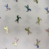 Square swatch double gauze fabric with small metallic/rainbow iridescent unicorns on white