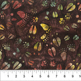 Tossed Animal Footprints Dark Brown fabric swatch (brown marbled look fabric with tossed animal footprints in various styles and colours - multi coloured marbled look prints)
