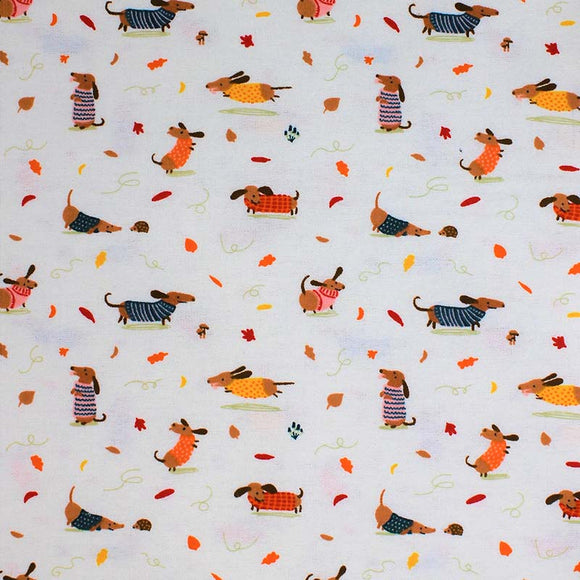 Square swatch Sweater Weather fabric (white fabric with tossed small illustrative brown Weiner style dogs allover with tossed red, orange and yellow leaves, dogs wearing sweaters)
