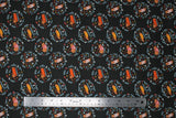 Flat swatch dog days autumn fabric (black fabric with tossed brown dogs in autumn sweaters in circular badges made up of greenery and mushrooms)