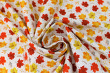 Swirled swatch Maple Foliage fabric (white fabric with tossed maple leaves in yellow, orange and red shades with tossed sprigs)